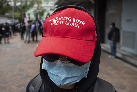 HONG KONG, CHINA - FEBRUARY 19, 2020:
A protester wearing a "Make Hong Kong Great Again" hat takes part in a protest against the use of a quarantine center in Cheung Sha Wan in Hong Kong.