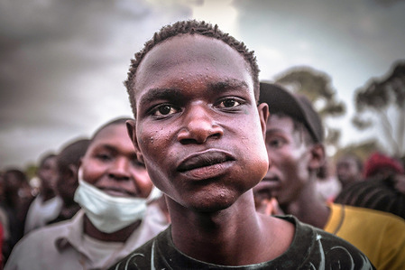 A fan is seen having a good time while Chewing Khat during a soccer match between Gogo boyz Fc from Kibera and Ping Fc from Dagoreti.