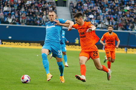 Artem Dzyuba (No.22) of Zenit and Ivan Kuzmichev (No.25) of Ural seen in action during the Russian Premier League football match between Zenit Saint Petersburg and Ural Yekaterinburg at Gazprom Arena. 
Final score; Zenit 3:1 Ural.