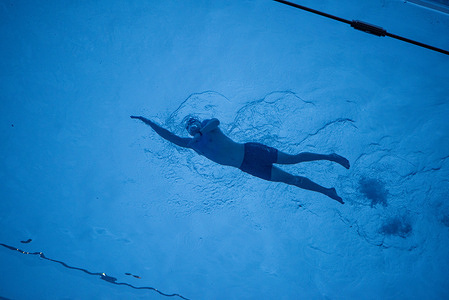 A swimmer swims at the Sky Pool. The Sky Pool at Embassy Gardens in Nine Elms, London, is the world’s first transparent floating swimming pool. It is installed 25 meters long between two 10-story residential buildings and 35 meters (115 ft) above the ground, this 50-tonne acrylic structure allows residents to swim between buildings with views of London.