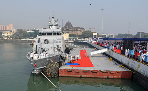 Navy personnel are seen standing on INS Mahe anchored for the commissioning ceremony at Naval Dockyard. The Indian Navy commissioned INS Mahe, the first of the indigenously designed and built Mahe-class Anti-Submarine Warfare Shallow Water Craft (ASW-SWC) at the event hosted at the Naval Dockyard. The ship takes her name from the historic coastal town of Mahe on the Malabar Coast. It is specially designed to undertake anti-submarine operations in coastal and shallow waters. Fitted with advanced weapons, sensors, and communication system enabling it to detect, track and neutralise sub-surface threats with precision.