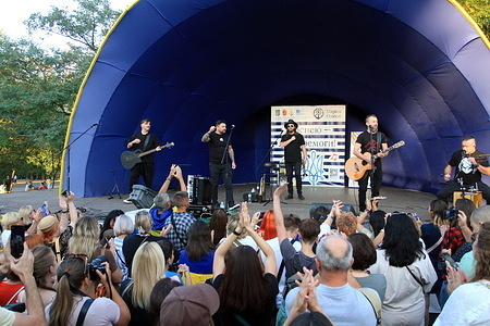 The Kozak System group seen performing at the Black Sea Steppe Festival at the Taras Shevchenko Central Park of Culture and Recreation. Kozak System is a Ukrainian rock band playing in the folk-punk style. The purpose of the event is to support the morale of the population during the ongoing military aggression of the Russian Federation.