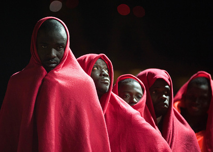 Migrants in line wait to disembark from a rescue vessel after their arrival at the Port of Malaga. Spanish Maritime Rescue service rescued a total of 183 migrants aboard dinghies at the Alboran Sea and brought them to Malaga harbour, where they were assisted by the Spanish Red Cross.