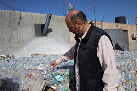 Environmental activist Adel Alratab arranges piled water bottles collected from the street to be recycled as part of the charity campaign. The Charitable Recycling Project aims to sell waste to provide assistance to needy families and organize work training courses for youths and women to provide them with a source of income.