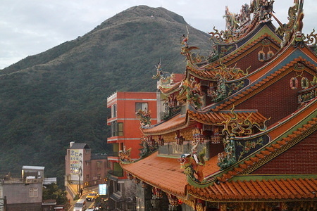 A temple at the forefront with a mountain in the background