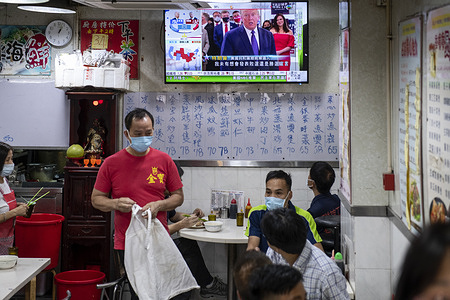 At a local restaurant, the Republican candidate Donald J. Trump appears on TV during news report about the US presidential election.
