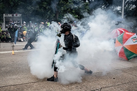 Protester returns a teargas canister during the demonstration.
Protesters attend a Global Anti-Totalitarianism March in Hong Kong - Demonstrations continue in Hong Kong marking one of the worst days of violence in 4 months of unrest.