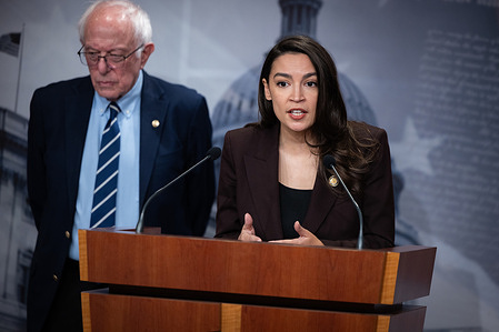 Congresswoman Alexandria Ocasio-Cortez (D-NY) speaks at a press conference with Senator Bernie Sanders (I-VT) on the introduction of the Artificial Intelligence Data Center Moratorium Act. The act would halt the construction of new data centers until federal regulations and safeguards could be put in place to safeguard humans, as well as protect workers and the environment.