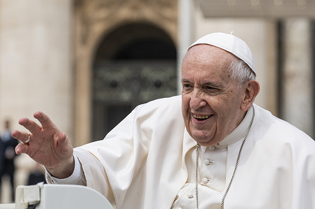 Pope Francis waves to the faithful as he leaves at the end of the weekly General Audience.