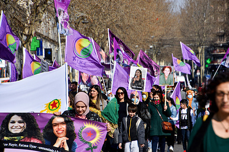 Kurdish protesters hold the purple flags and the placards during the demonstration on International Women's Day in Marseille.
