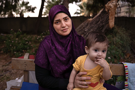 Alaa Akel and her baby boy seen outside a hotel where they live with 700 other people. They had to flee their home in Dahiye because of heavy shelling. The war between Israel and Hezbollah continues unabated. More than 1.2 million people have been forced to flee their homes and more than 1,400 people have been killed.