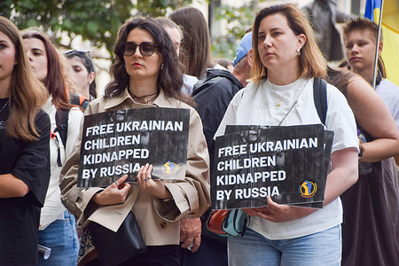 Protesters hold placards during the demonstration in Parliament Square demanding the release of Ukrainian children kidnapped by Russia and an end to Russian aggression in Ukraine.
