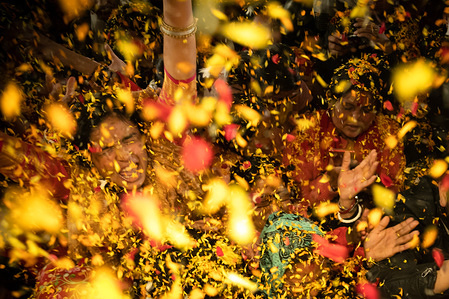 Devotees sing and dance as flower petals are being thrown during the Gaura Purnima festival in Kathmandu.
The festival is celebrated to mark the day when Lord Krishna changed his colour to golden and advent as Gauranga.