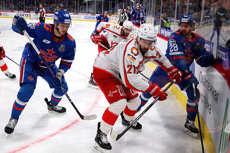 SKA Hockey Club player, Sergei Tolchinsky (28), Zakhar Bardakov (10) and Avtomobilist Hockey Club player, Maxim Osipov (21) seen in action during the match the Kontinental Hockey League, Gagarin Cup, match 5, 1/4 finals season KHL 2023 - 2024 between SKA Saint Petersburg - Avtomobilist Yekaterinburg at the SKA Arena. (Final score; SKA Saint Petersburg 4:5 Avtomobilist Yekaterinburg)