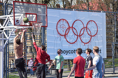 People play basketball on the background of a banner with the inscription #BoycottRussianSport on one of the sports grounds in Lviv. Ukraine and many countries around the world are demanding that Russian athletes be barred from the Olympic Games and other international competitions because of the Russian-Ukrainian war started by Russia. Many Ukrainian athletes who defended Ukraine from the Russian aggressor have already died in this war. In support of the boycott, a banner with the inscription #BoycottRussianSport was hung at one of the sports grounds in Lviv.
