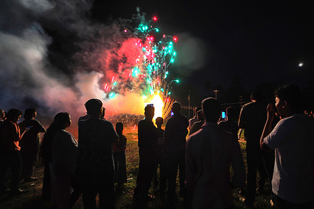 People seen enjoying fireworks show in Baruipur (almost 50km from Kolkata) during the Kali Puja Celebration. Kali, the Hindu goddess of destruction, creation, and time, is honored during the Kali Puja, a major festival celebrated mainly at West Bengal in different months as per local ritual.