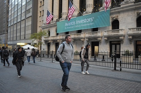 People walk past the New York Stock Exchange in the Financial District in Manhattan, New York City.