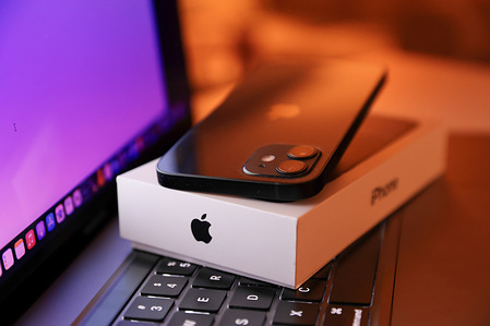 In this photo illustration, Apple’s iPhone 12 seen placed on a MacBook Pro.