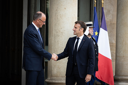 French President Emmanuel Macron (R) welcomes the German Chancellor Friedrich Merz (L) at the Elysee Palace.