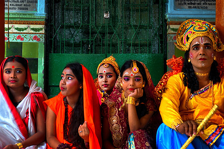 Children seen dressed up as different Hindu Godess during Gajan Festival. Gajan Festival is a Hindu Traditional Folk Festival celebrated mainly in the Eastern part of India at the end of Bengali year / Mid of April , where people dress up as different Hindu God & doing different ritual practices like Face painting , Piercing , Playing with fire to satisfy their belief / God for the wellness of the Family .