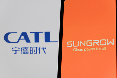 In this photo illustration, the Sungrow Power logo is seen displayed on a smartphone screen with Contemporary Amperex Technology Co. (CATL) logo in the background.