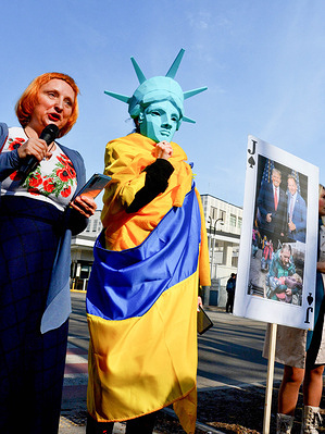 An activist dressed as the Statue of Liberty seen during a "Wake Up, America" demonstration outside the US Embassy in Kyiv to call for more support for Ukraine.