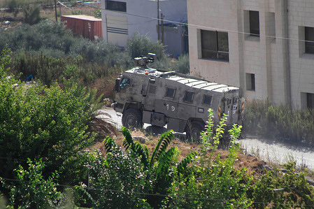 An Israeli armored military vehicle storm the Palestinian city of Tulkarm in the northern occupied West Bank.