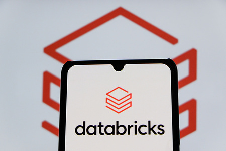 In this photo illustration, the Databricks logo displayed on a smartphone and in the background.