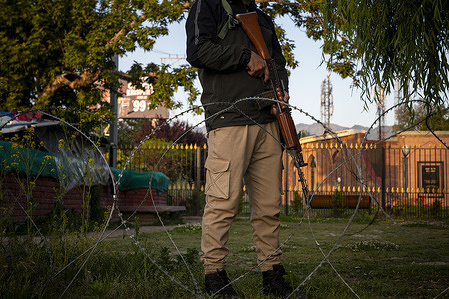 Indian policeman stands alert along a street in Srinagar, the summer capital of Jammu and Kashmir.