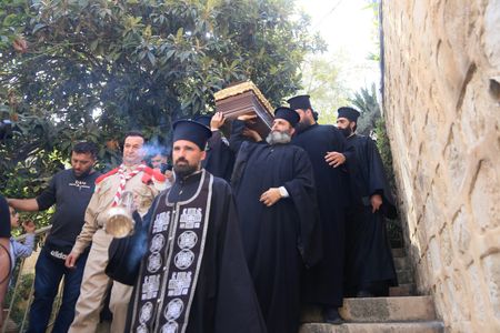Christian clergy and monks participate in carrying the body of Archimandrite Ioustinos Mamalos, the rector of Jacob's Well Church. Justinus was a Greek monk who served the church and monastery for 40 years. He was laid to rest at the entrance of the church under the administration of the Palestinian Authority.