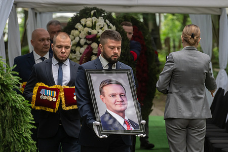 People carry the portrait of Roman Starovoit, former Minister of Transport during the funeral ceremony at Smolensk Cemetery. Former Russian Transport Minister Roman Starovoit was found dead with a gunshot wound in his car near Moscow on July 7, 2025, hours after President Putin announced his dismissal. Authorities have launched an investigation, with suicide as the leading theory.
