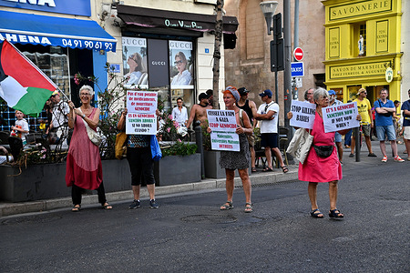 Protesters waving a Palestinian flag and holding placards gather on Rue de la Republique. Around ten pro-Palestinian demonstrators gathered spontaneously on Rue de la République.