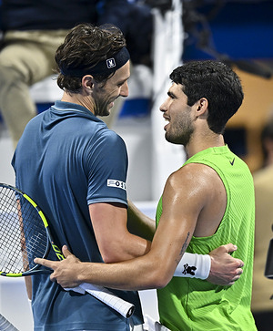 Carlos Alcaraz (R) of Spain shake hands with Arthur Rinderknech of France after winning the men's singles round of 32 match at the ATP Qatar Exxonmobil Open 2026 tennis tournament at the Khalifa International Tennis Complex. Carlos Alcaraz won against Arthur Rinderknech 6-4,7-6.  