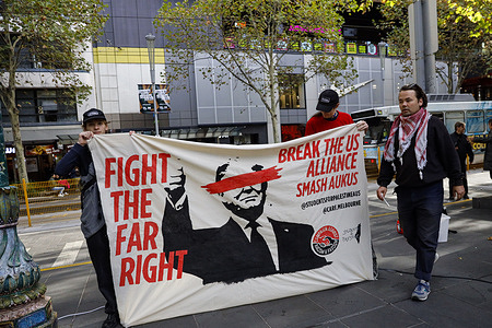 Protesters hold a banner during the rally. A national anti-Trump rally was held across multiple Australian cities including Melbourne where participants denounced U.S. President Donald Trump’s policies and global influence. Demonstrators criticized his administration’s stances on immigration, climate change and foreign affairs reflecting broader international concerns over the resurgence of authoritarian populism.