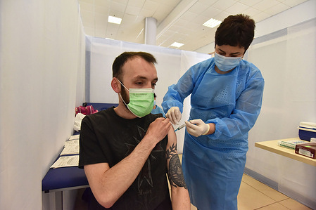 A healthy worker injects a dose of AstraZeneca Covid-19 vaccine to a man at a vaccination center.
The city of Lviv in western Ukraine is offering the IT industry workers to be vaccinated with the AstraZeneca Covid-19 vaccine at a vaccination center located at the Arena Lviv stadium.