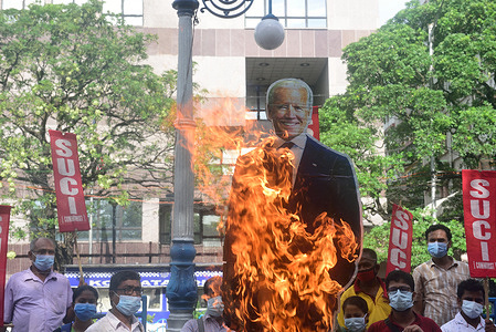 SUCI party members burn an effigy of U.S president Joe Biden in front of the American Consulate during the demonstration.
Socialist Unity Centre of India (SUCI) party members rally against the ongoing protest in Cuba, a protest against the Communist Government of Cuba. According to the SUCI party the protest is happening due to the sanctions imposed on Cuba by the U.S government.