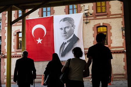 The Turkish flag displayed beside a portrait of Mustafa Kemal Ataturk, founder of the Turkish Republic and first president. An iconic symbol of Turkish nationalism as the Turkish opposition party struggles with a political crisis.