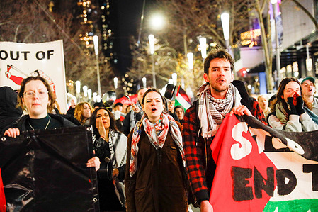 Protesters chant slogans while holding a banner during the rally. A Friday night snap rally was held to show solidarity with Palestinians in Gaza where demonstrators used pots and pans to create noise and draw attention to the worsening humanitarian crisis. Protesters called for an immediate ceasefire and raised awareness about the ongoing famine and the Israeli military assault. According to recent reports, millions of Palestinians are facing catastrophic food insecurity with children particularly affected by malnutrition and starvation.