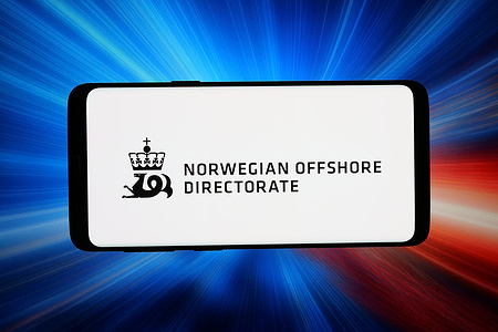 In this photo illustration, the logo of Norwegian petroleum agency Sokkeldirektoratet is displayed on a smartphone in front of abstract background on computer screen.