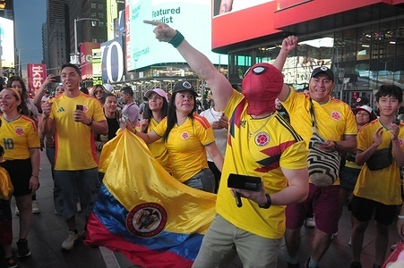 A fan of the Colombian national soccer team wears a Spiderman mask in Times Square, Manhattan, New York City.