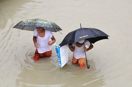 Two boys walking through a submerged road during the aftermath.
One third of Bangladesh is under water after some of the heaviest rains in a decade leaving more than 3 million people affected with homes and roads in villages flooded, Flood Forecasting and Warning Centre (FFWC) officials said.