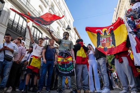 Right-wing counter-protesters seen waving flags and shouting slogans during a protest in downtown. Right-wing counter-protesters leaving the Hispanic Heritage Day parade gathered around Puerta del Sol in Madrid, to heckle activists camped out in support of housing rights. Spanish National Police set up a security barrier in the central square to separate the nationalist groups from demonstrators protesting the nation's severe housing and eviction crisis.