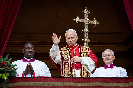 Pope Leo XIV greets the faithful after the "Urbi et Orbi" blessing from the balcony of St. Peter's Basilica overlooking St. Peter's Square.