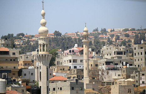 A view of mosque minarets with houses of Jewish settlers visible in the background in the West Bank. Jewish settlers burned two mosques and sprayed paint on them, inciting slogans calling for revenge in Hebrew in the villages of Jaljulia and Mazra'at al-Nubani, north of Ramallah, which are under the control of the Palestinian Authority in the West Bank, headed by President Mahmoud Abbas.