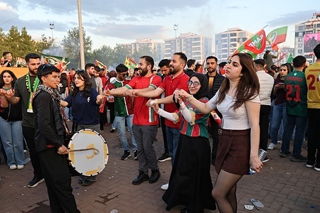 A group of fans is seen celebrating Amedspor's championship by dancing. The championship victory and promotion of Amedspor, the football club from Diyarbakir, Turkey’s largest Kurdish-majority city, to the Turkish Super League were celebrated with a massive festival at Newroz Park attended by hundreds of thousands of supporters. Players lifted the championship trophy during the celebrations, with the club receiving support from Kurdish communities across Turkey, Iraq, Syria, Iran, and Europe. The event took place amid ongoing peace talks between Turkish authorities and imprisoned Kurdistan Workers’ Party (PKK) leader Abdullah Öcalan after the group announced it had laid down its arms.