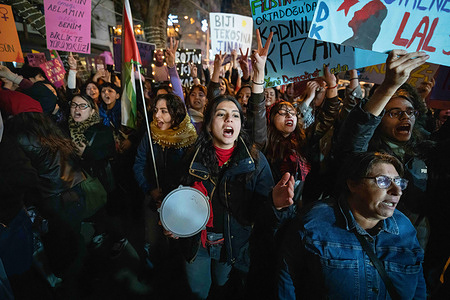 Women are seen chanting slogans during the march. On International Women's Day, women's organizations and civil society groups in Ankara held a night march.