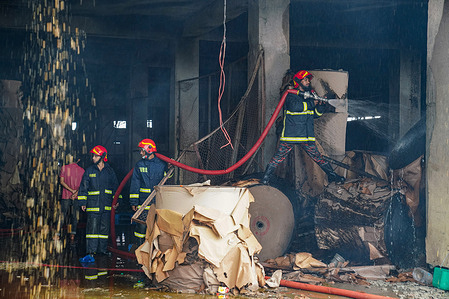 Firefighters extinguish a fire at the ground floor of a burnt Hashem Foods Limited factory in Rupganj, Narayanganj district on the outskirts of Dhaka.A massive fire in a Bangladesh food processing factory has killed at least 52 people trapped by flames that forced many workers to leap for their lives from the upper floors, citing police officials.