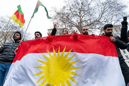 Protesters chant slogans behind a Kurdistan Flag during the demonstration. Syrian Kurdish protesters gathered outside Downing Street in London to call for the removal of extremist groups from Syria and to urge the UK government to impose sanctions on the Syrian government.