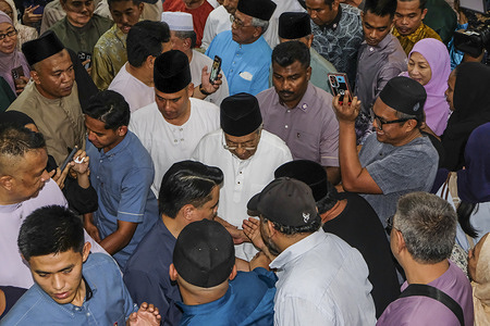 Supporters crowd around Tun Mahathir Mohamad (C), hoping to greet and shake hands at Masjid Saidina Umar Al-Khattab in Kuala Lumpur during a special prayer event held in conjunction with his 100th birthday. Tun Mahathir Mohamad marked his 100th birthday with a special prayer event held at Masjid Saidina Umar Al-Khattab in Kuala Lumpur. Attended by hundreds of people, including family members, political figures, and loyal supporters. The event served as a moment of reflection and tribute to Malaysia's longest-serving prime minister. A quiet yet significant milestone in the life of a stateman who remains a prominent figure in the national consciousness.