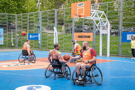 Men seen playing basketball in wheelchairs. Veterans of the Russian-Ukrainian war, players of veteran national teams and influencers play basketball “GART | Wheelchair Basketball”, on a basketball court in Lviv with the support of the Center for Initiatives “Return Alive” and the Ministry of Veterans, in Lviv. This is an event where anyone who wants can join and try their hand at the game. The event was also attended by skeleton athlete, Olympic flag bearer, Vladyslav Geraskevych, who honored the fallen athletes with his “Helmet of Memory”.